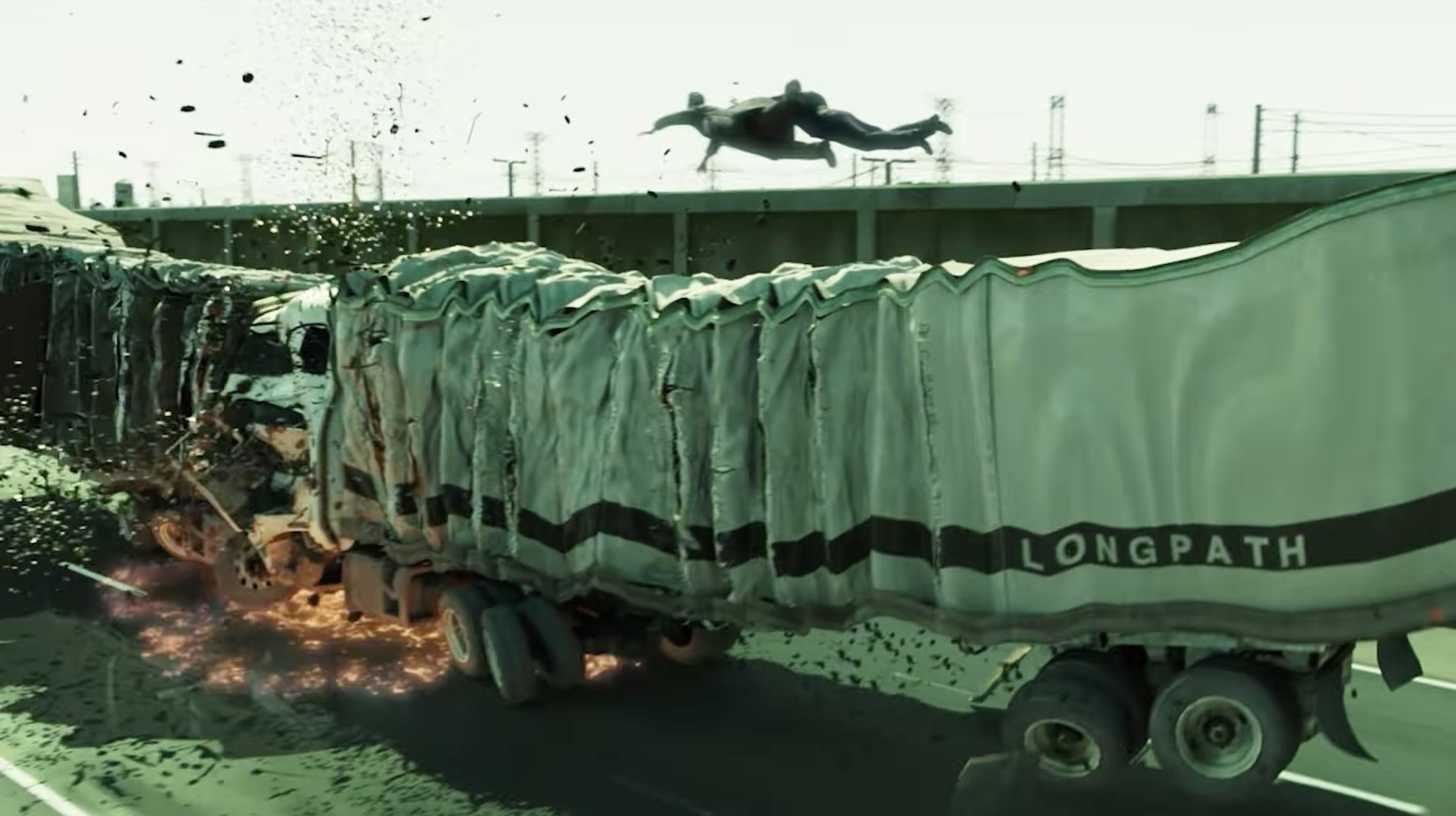 Neo surrounded by monitor images in The Matrix Reloaded